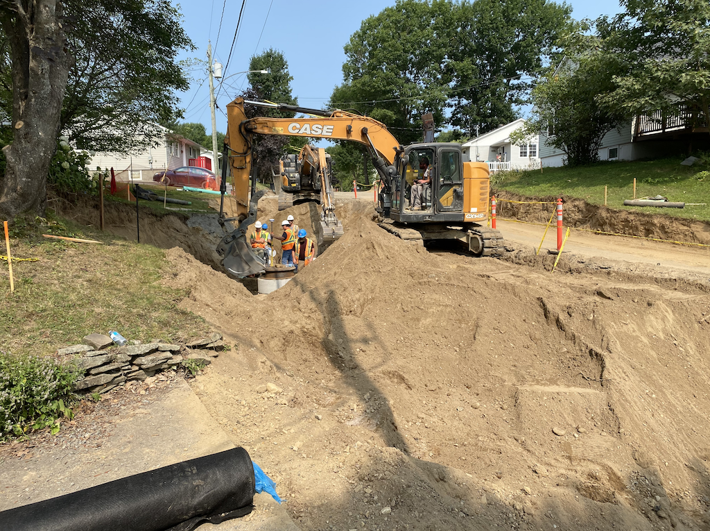 Sixx feet tall guys working in the pit in front of our neighbour's driveway @ 10:35 am this morning