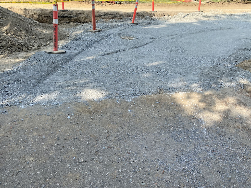 Our driveway in the foreground and the newly finished ramp up to it -