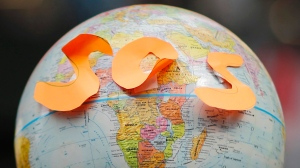 Globe with S-O-S in orange letters stuck to in near the equator